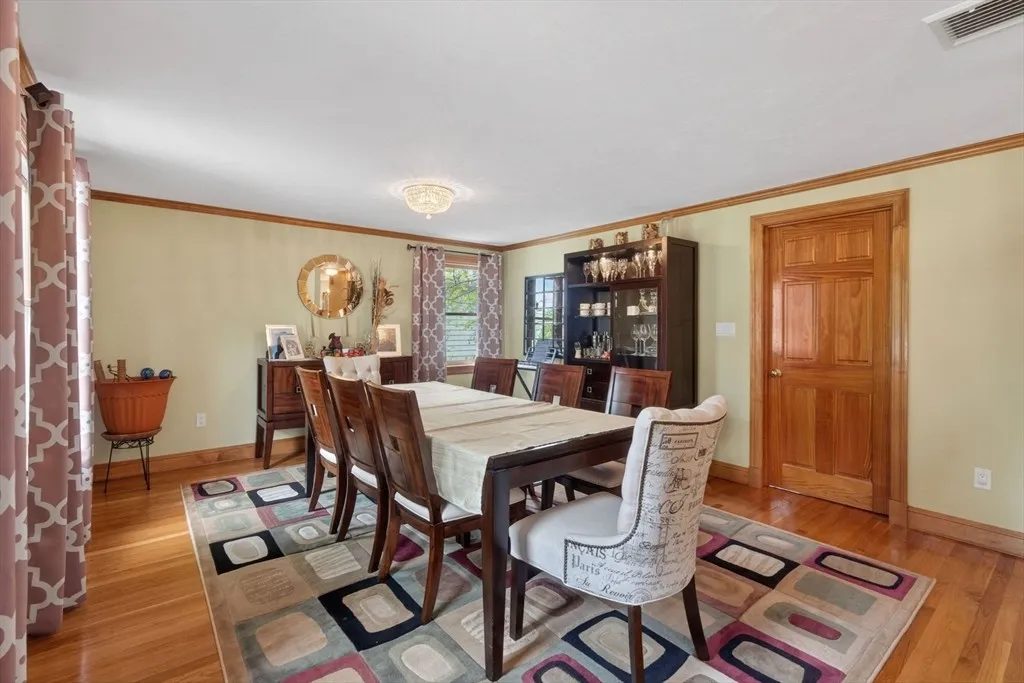 The formal dining room at 8 Hawthorne St set for dinner under a statement light fixture