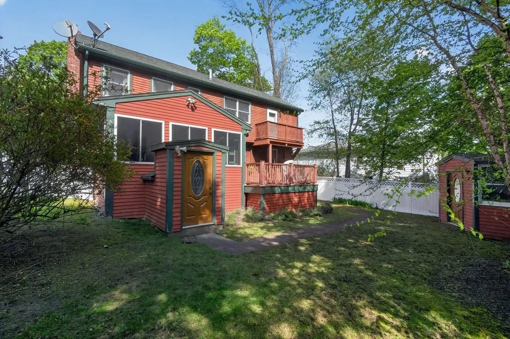 The fenced backyard at 8 Hawthorne St with a raised deck and lawn for summer evenings
